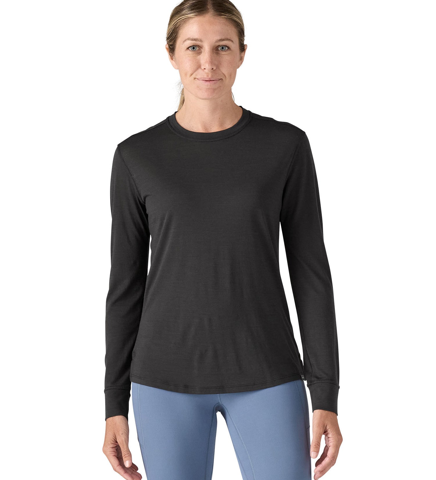 A woman modelling the Patagonia women's capilene cool merino blend long sleeve t-shirt in black available at Babipur showing the front fit