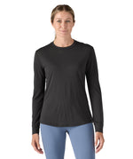 A woman modelling the Patagonia women's capilene cool merino blend long sleeve t-shirt in black available at Babipur showing the front fit