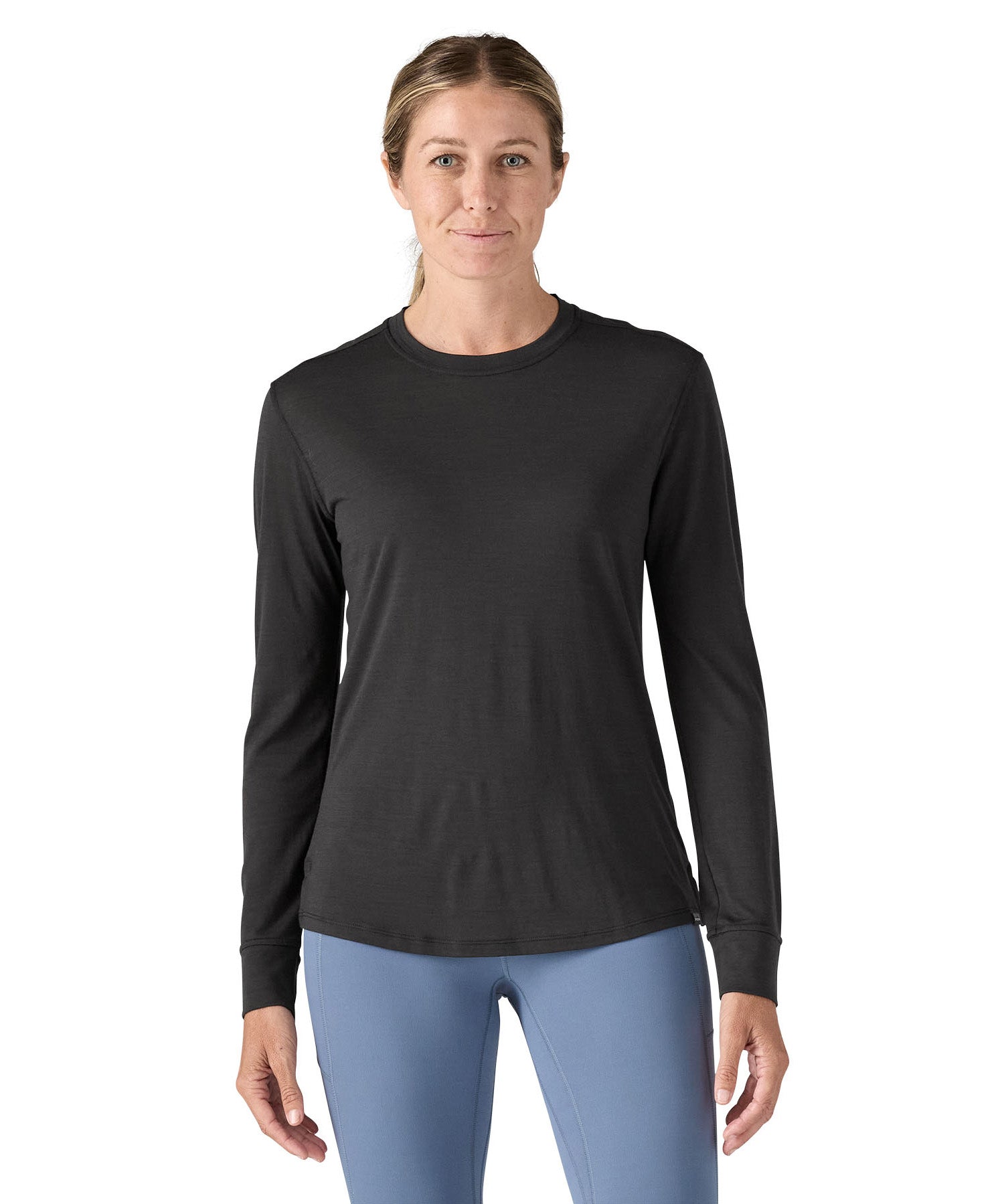 A woman modelling the Patagonia women's capilene cool merino blend long sleeve t-shirt in black available at Babipur showing the front fit