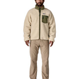 A man wearing the Patagonia classic retro x jacket in natural/green available at Babipur.