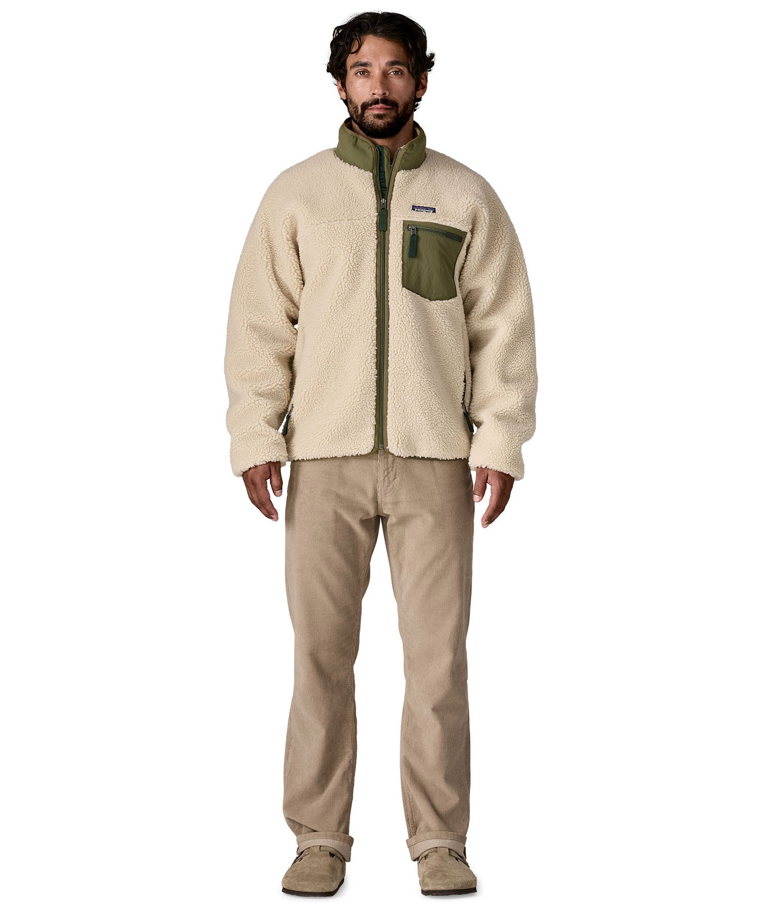 A man wearing the Patagonia classic retro x jacket in natural/green available at Babipur.
