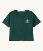 Patagonia women's unity Fitz roy responsibili tshirt available at Babipur. A green, short sleeved and boxy top with a circular brand logo printed on the chest. 