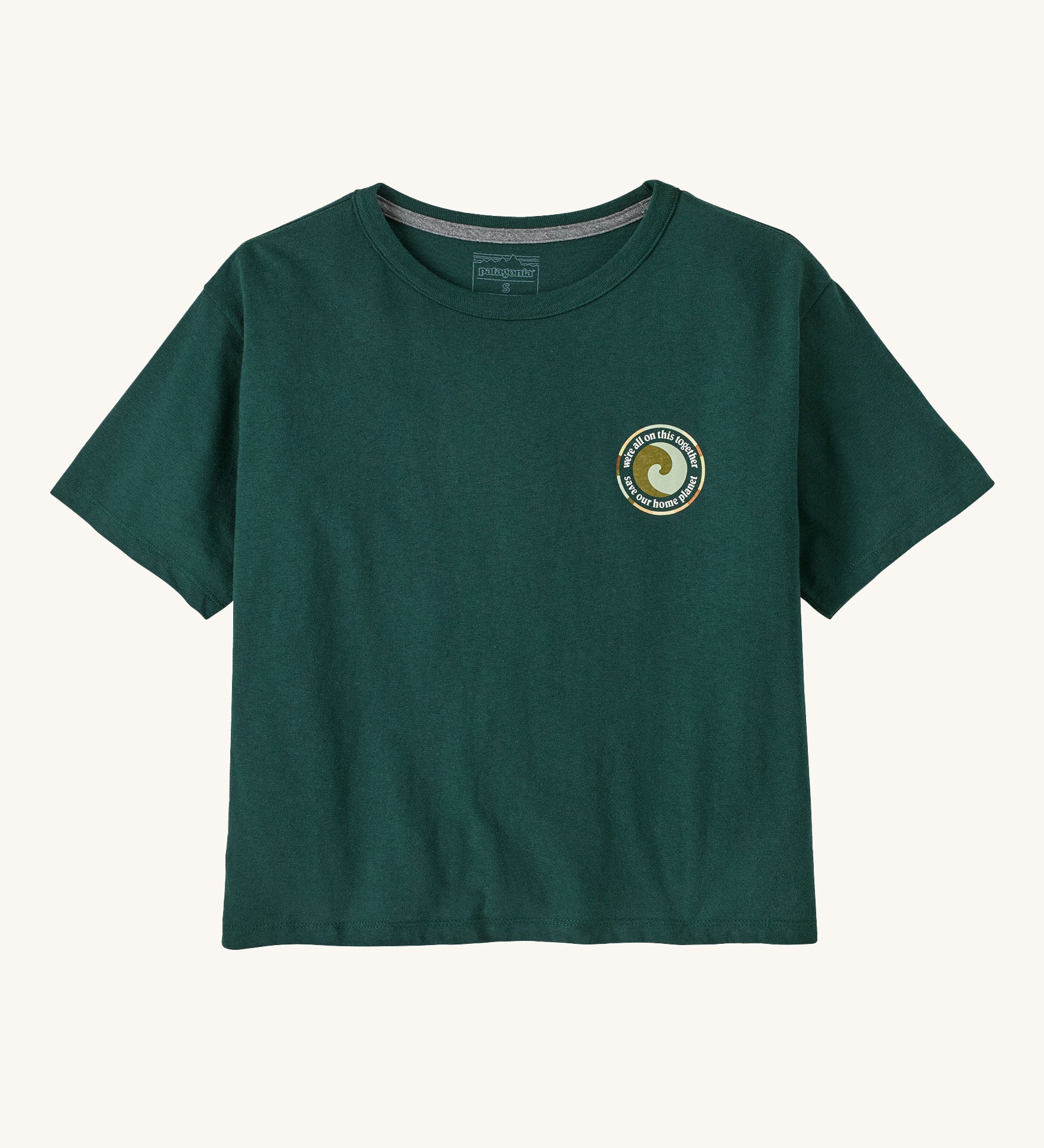 Patagonia women's unity Fitz roy responsibili tshirt available at Babipur. A green, short sleeved and boxy top with a circular brand logo printed on the chest. 
