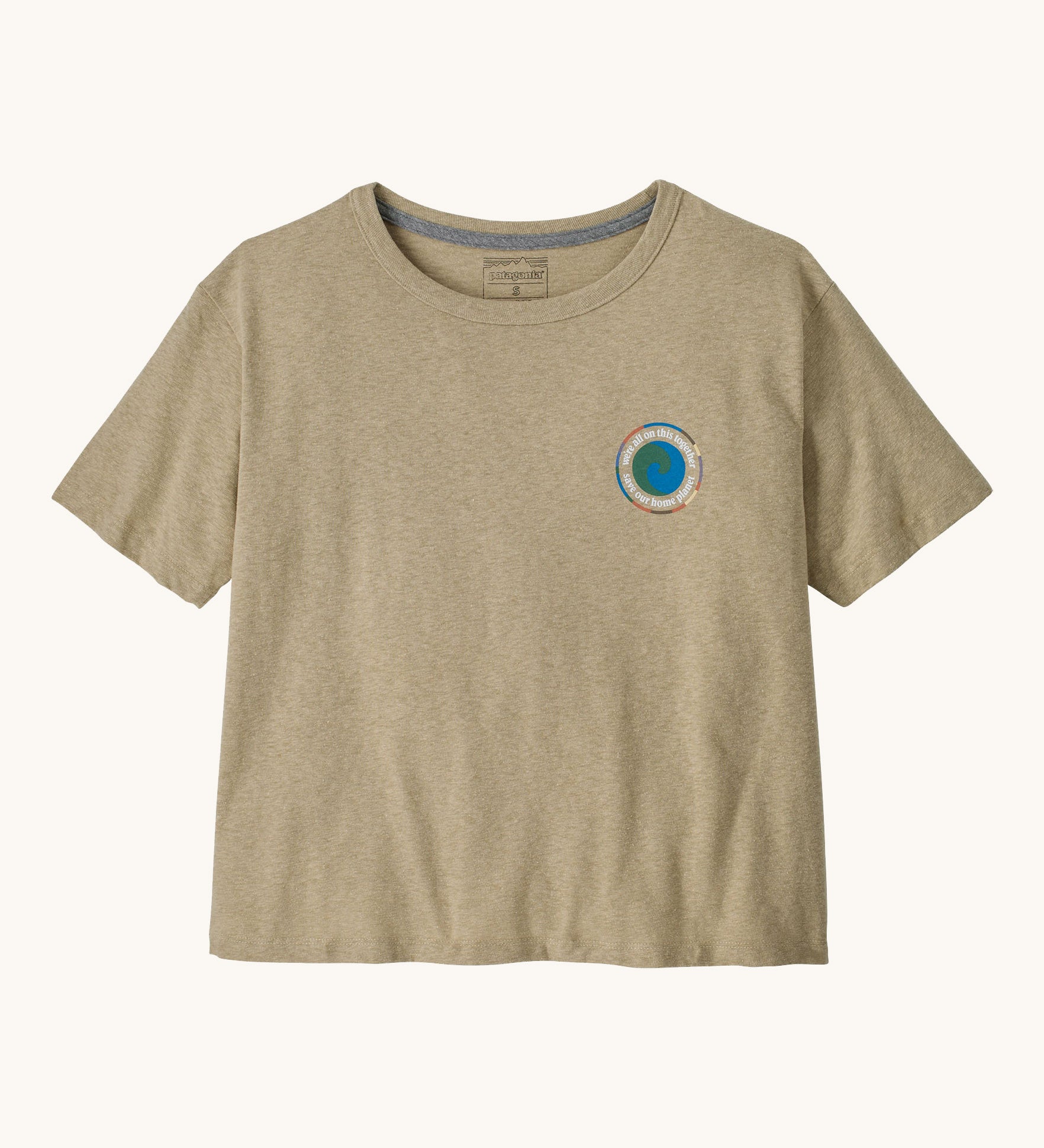 Patagonia women's unity Fitz roy responsibili tshirt available at Babipur. A light brown, short sleeved and boxy top with the brand circular logo printed on the chest. 