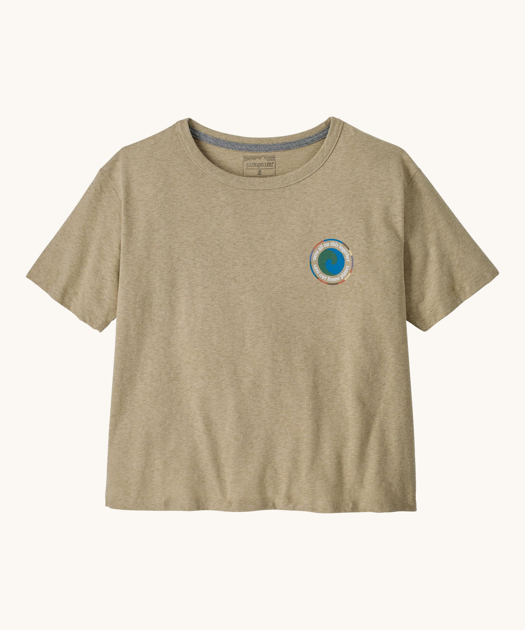 Patagonia women's unity Fitz roy responsibili tshirt available at Babipur. A light brown, short sleeved and boxy top with the brand circular logo printed on the chest. 