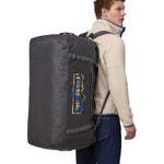 A person wearing the Patagonia Black Hole Duffel 100L Ink Black on their back