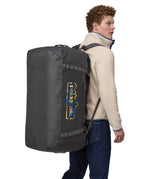 A person wearing the Patagonia Black Hole Duffel 100L Ink Black on their back