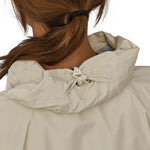 A closer look at the hood on the Patagonia Women's Torrentshell 3L Rain Jacket. The image shows a person from the back wearing the jacket, with an elasticated clip on the hood to keep the inside of the hood dry
