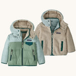 Patagonia little kids tribbles hoody. A reversible coat showing a blue and green hooded coat and natural fleece alternative side. Features a small chest pocket and side pockets
