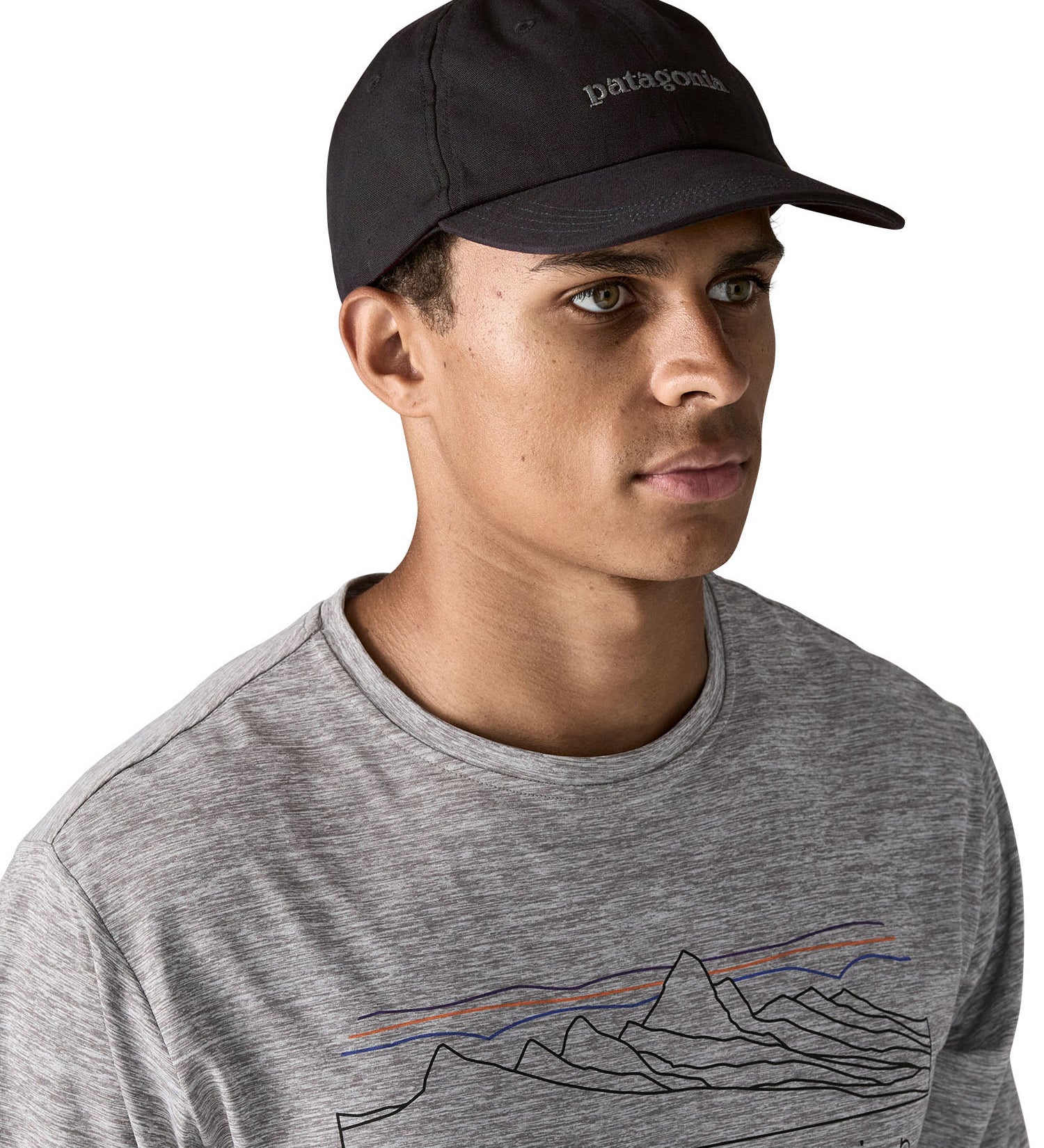 Man wearing Patagonia's organic cotton fitz roy trad cap in black with brand text on the front. 