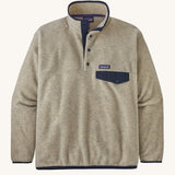 Patagonia Men's Synchilla Snap-T Fleece - Oatmeal Heather. A cream oatmeal coloured fleece with navy blue pocket flap, buttons and piping