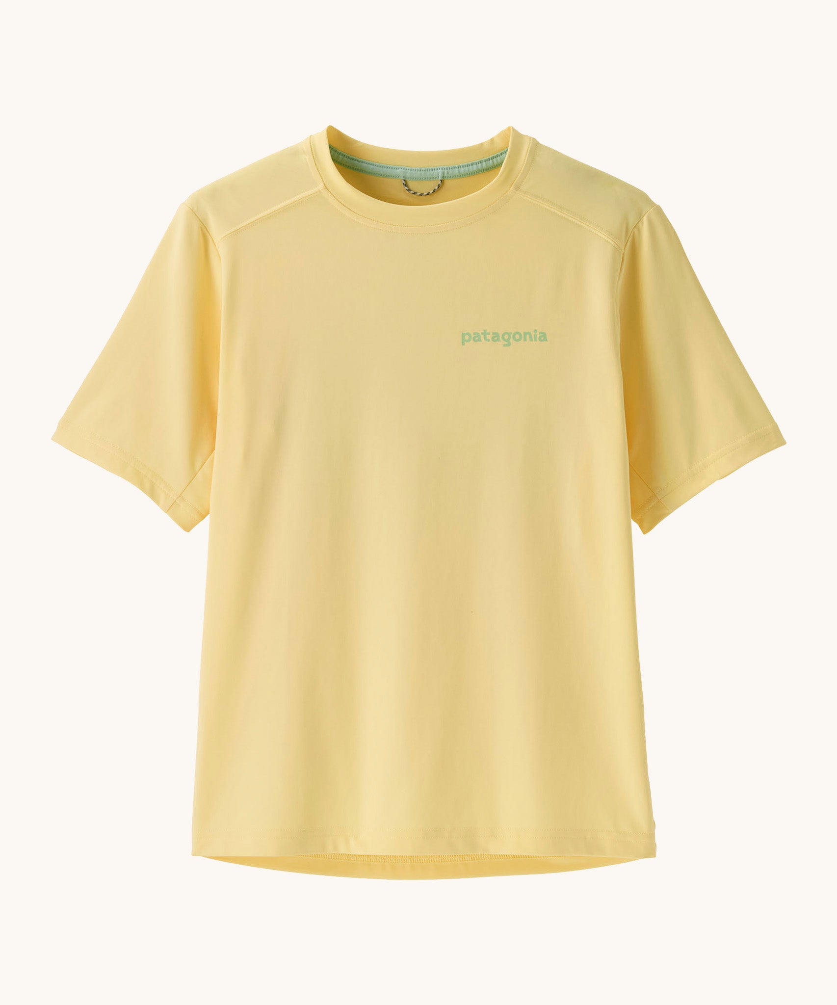 Patagonia recycled polyester kids capilene short sleeve t-shirt in yellow with light green brand text on chest. T-shirt has a regular fit