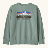 Patagonia Kids Cotton crew Sweatshirt in Cover Green. A sage green body with a vintage-style Patagonia Fitz Roy Foothills logo on the chest.