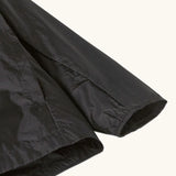 Close up of Patagonia's 100% recycled nylon kids houdini jacket in black showing elasticated cuff detail