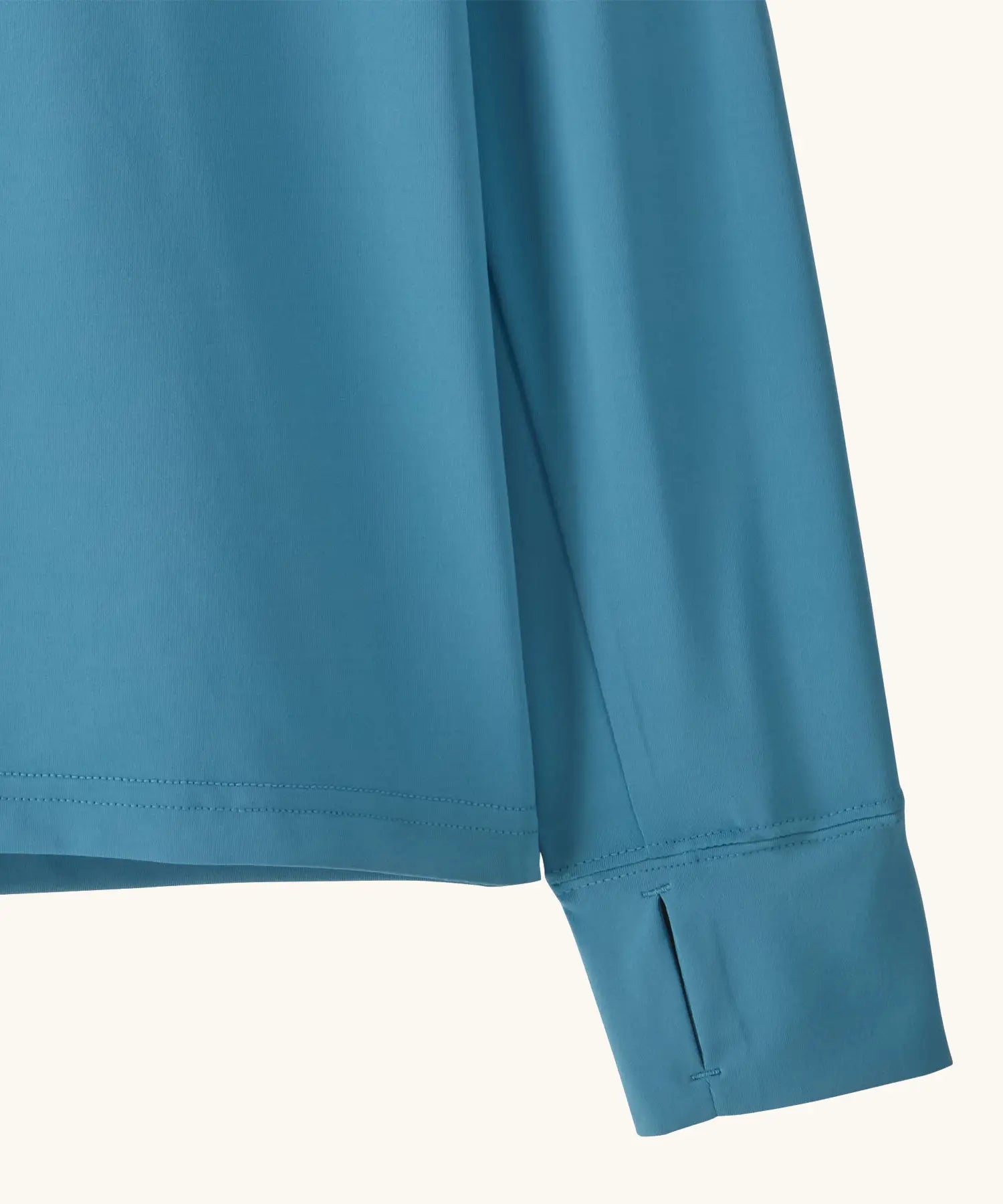 Close up of Patagonia kids long sleeve capilene tshirt in bright blue showing thumb hole on sleeve