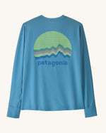 Patagonia kids long sleeve capilene tshirt in bright blue with circular brand patch on upper back 
