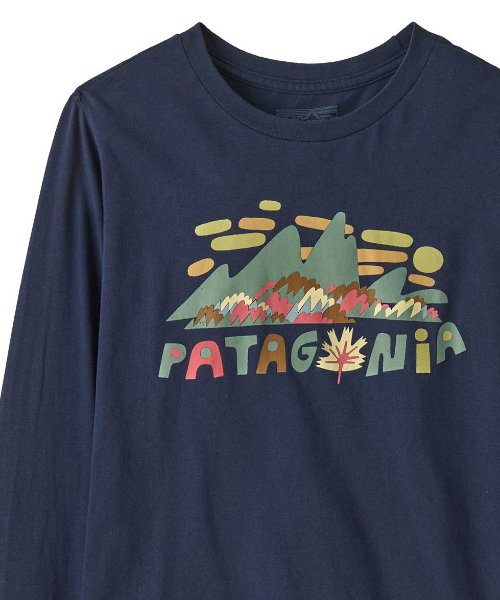 A close up of the front of the Patagonia kids long sleeve graphic top in fitz roy foliage/navy available at Babipur.. A 100% regenerative cotton top with long sleeves in navy. Features a funky mountain branding design on the front.