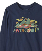 A close up of the front of the Patagonia kids long sleeve graphic top in fitz roy foliage/navy available at Babipur.. A 100% regenerative cotton top with long sleeves in navy. Features a funky mountain branding design on the front.