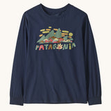 Patagonia kids long sleeve graphic top in fitz roy foliage/navy available at Babipur.. A 100% regenerative cotton top with long sleeves in navy. Features a funky mountain branding design on the front.