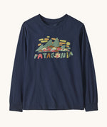 Patagonia kids long sleeve graphic top in fitz roy foliage/navy available at Babipur.. A 100% regenerative cotton top with long sleeves in navy. Features a funky mountain branding design on the front.