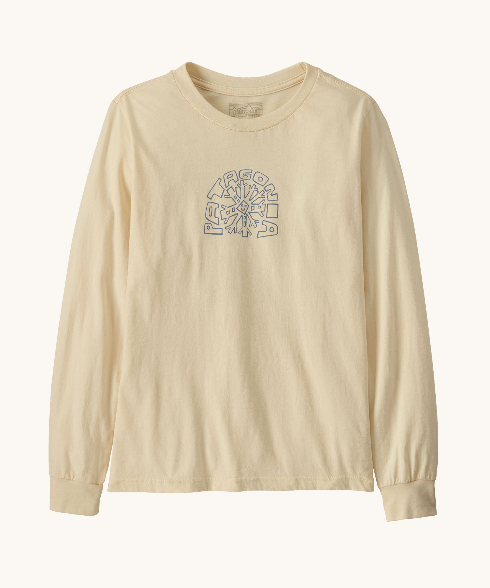 Patagonia kids long sleeve graphic top in skisel/undyed natural available at Babipur.. A 100% regenerative cotton top with long sleeves in cream. Features a funky snowflake branding design on the front.