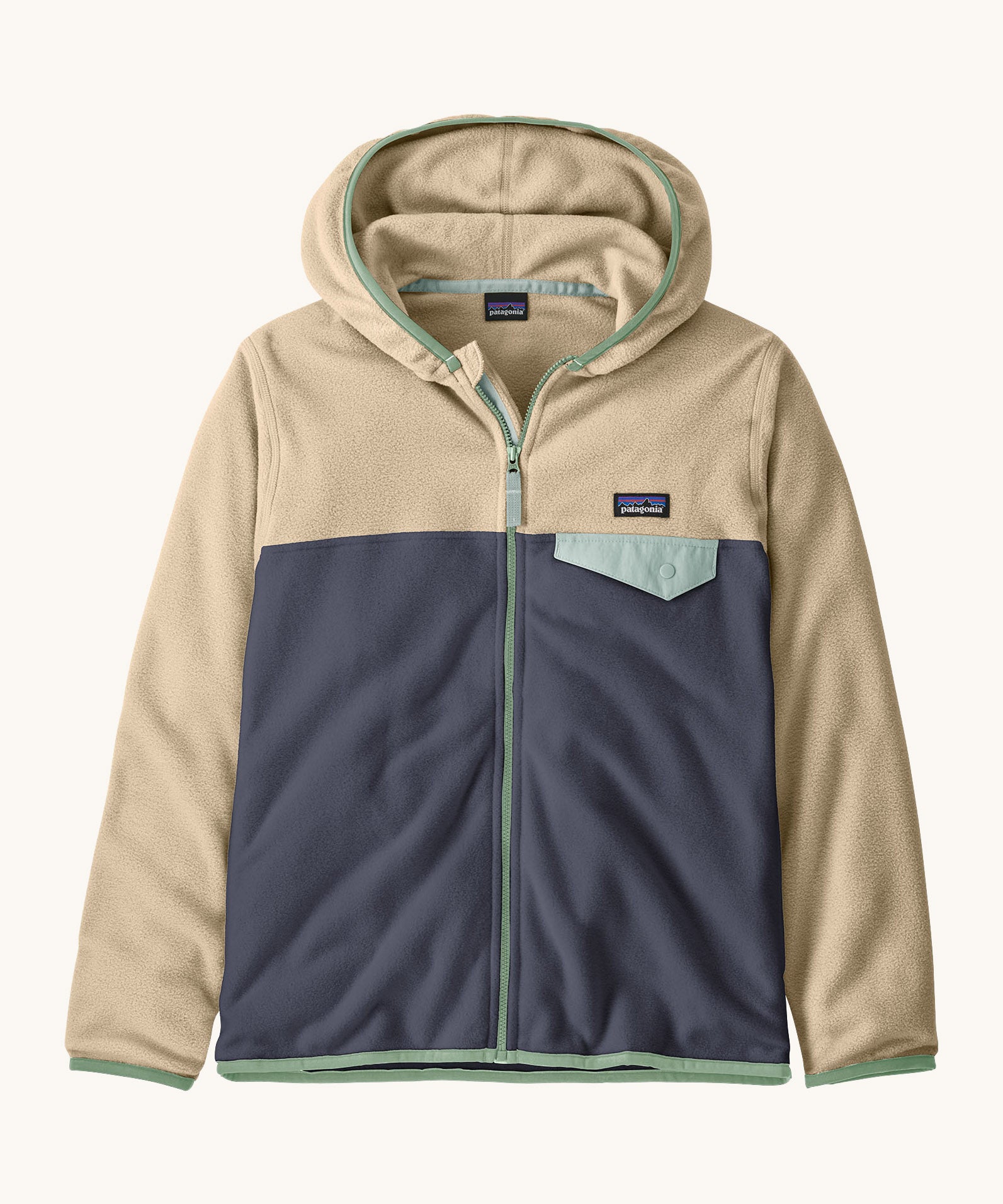 Patagonia kids micro d snap t fleece in smolder blue available at Babipur.  100% recycled polyester soft hooded fleece in beige and navy with green trim. Features a full length zip and a light blue chest pocket