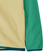 Close up of Patagonia kid's microdini snap-t hooded jacket in yellow and green showing side pockets and blue hem and cuff trim