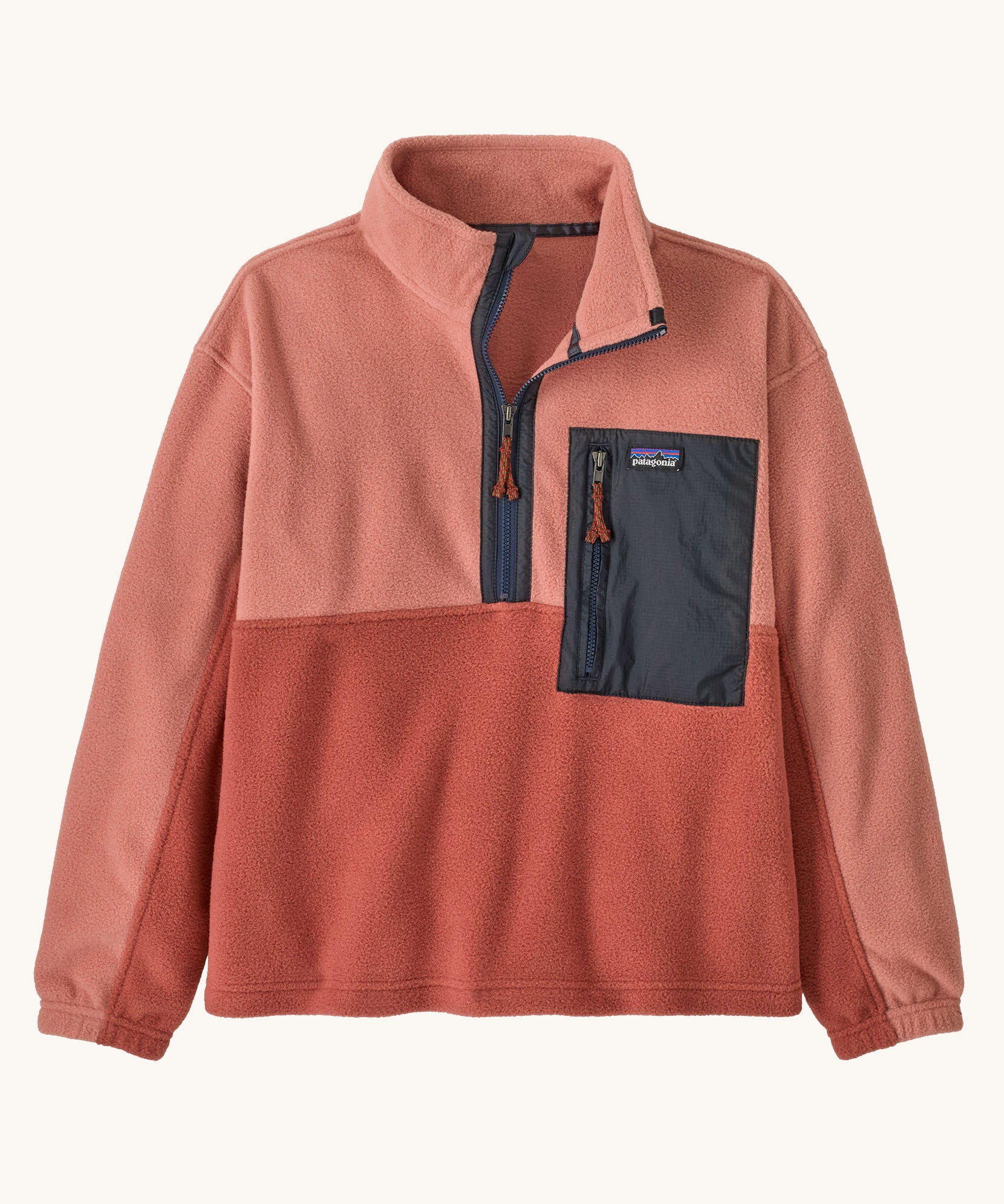 Patagonia kids microdini 1/2 zip pullover in potters red available at Babipur. A 100% recycled polyester soft fleece in pale red with navy trim. Features a turn up collar with a half length zip, elasticated cuffs and a chest pocket.