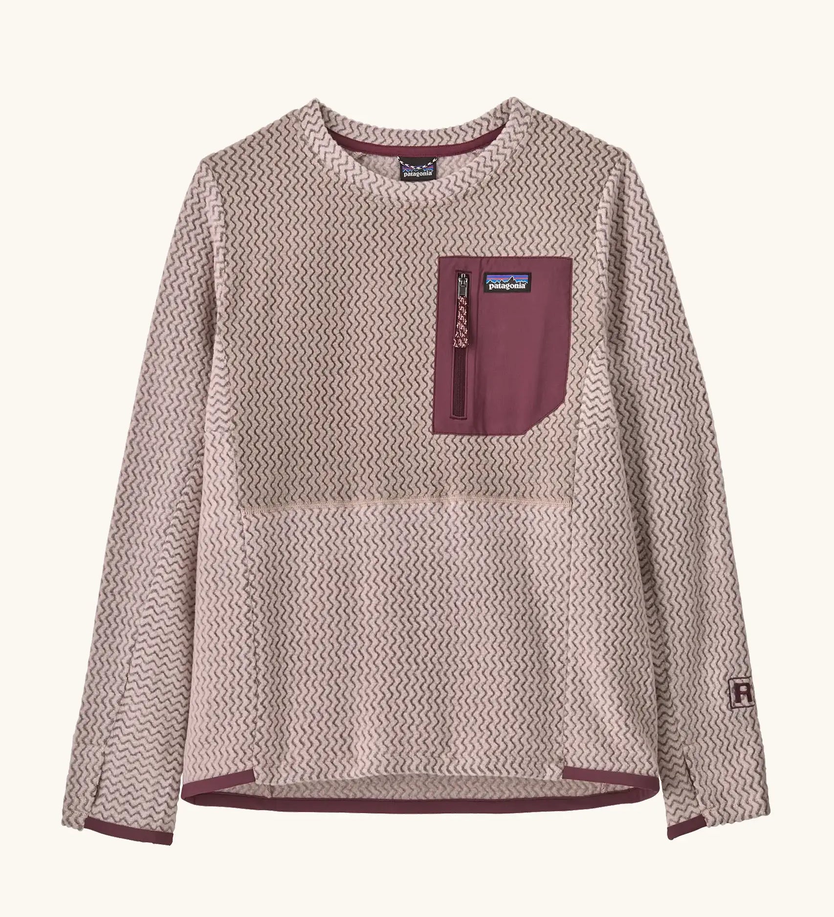Patagonia Kids R1 Air Crew in pink frost. Pale pink ribbed body with contrasting maroon binding and square chest zip pocket, and thumb holes.
