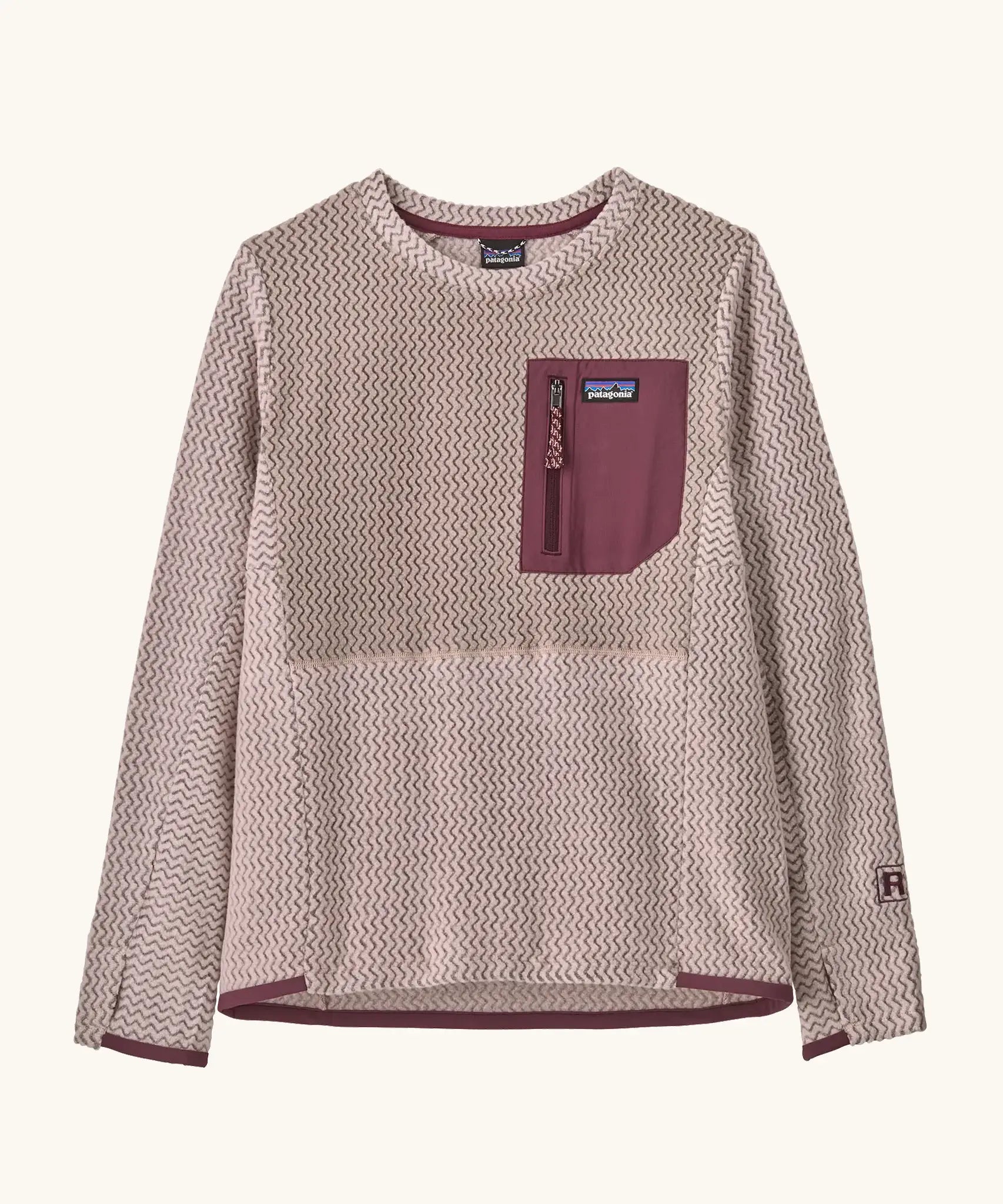 Patagonia Kids R1 Air Crew in pink frost. Pale pink ribbed body with contrasting maroon binding and square chest zip pocket, and thumb holes.