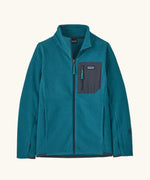 Patagonia Kids R1 Air Full-Zip Fleece Jacket in Glacial Blue. Deep blue ribbed body with dark grey binding, square chest pocket and full front zip. With thumb holes.