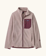 Patagonia Kids R1 AIr Full-Zip Fleece Jacket in Pink Frost. Pale Pink ribbed body with maroon binding, chest pocket and zip. And thumb holes on sleeves.