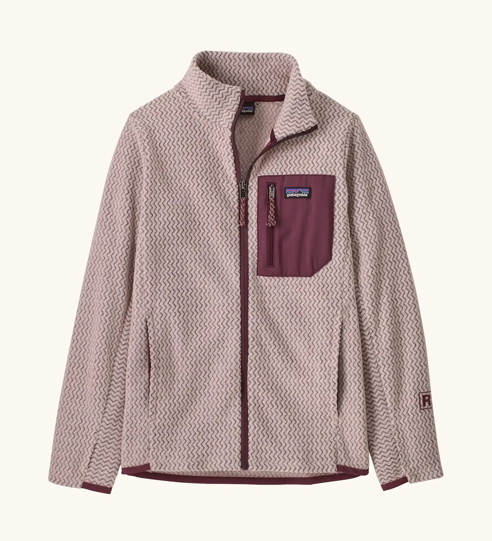 Patagonia Kids R1 AIr Full-Zip Fleece Jacket in Pink Frost. Pale Pink ribbed body with maroon binding, chest pocket and zip. And thumb holes on sleeves.