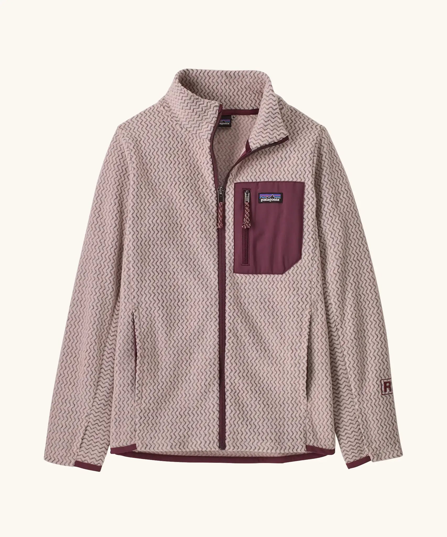 Patagonia Kids R1 AIr Full-Zip Fleece Jacket in Pink Frost. Pale Pink ribbed body with maroon binding, chest pocket and zip. And thumb holes on sleeves.