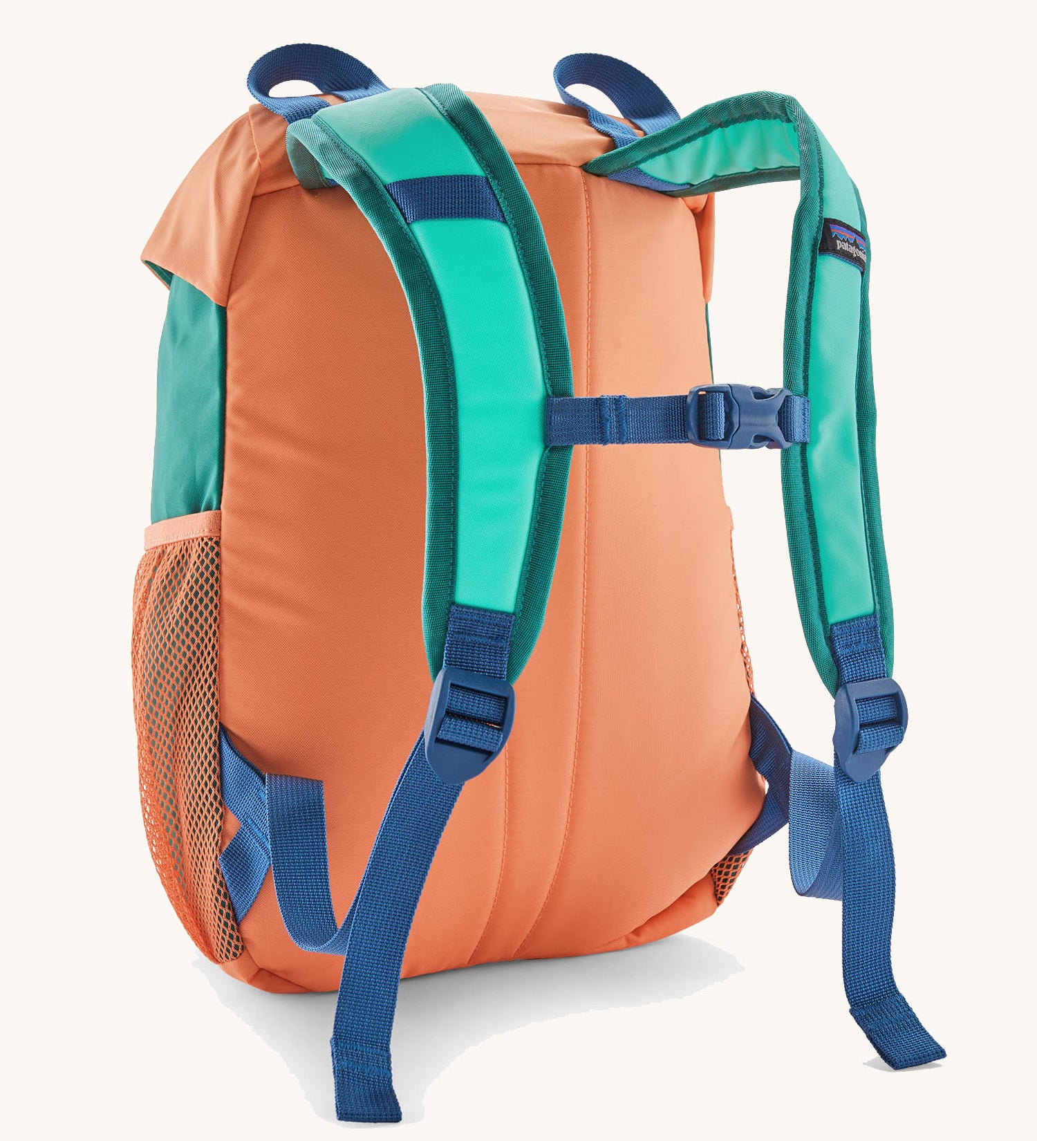 Patagonia kids refugito 12L day pack in green and pale orange block colour. Shows blue shoulder straps and orange back panel