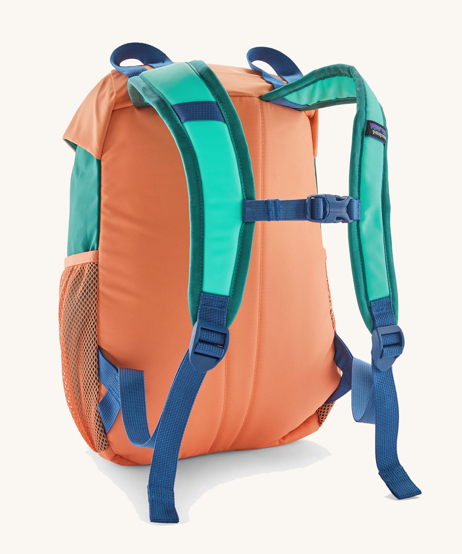 Patagonia kids refugito 12L day pack in green and pale orange block colour. Shows blue shoulder straps and orange back panel