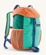Patagonia kids refugito 12L day pack in green and pale orange block colour. Shows front buckle lid fastener and mesh pockets