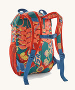 Patagonia kids refugito 12L day pack in red with a repeating tropical flower design. Shows shoulder straps with blue buckle 