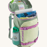 Patagonia refugito 18 litres daypack in ellwood green with the lid open revealing items in the main compartment and zip compartment on the inside.  Backpack available at Babipur.