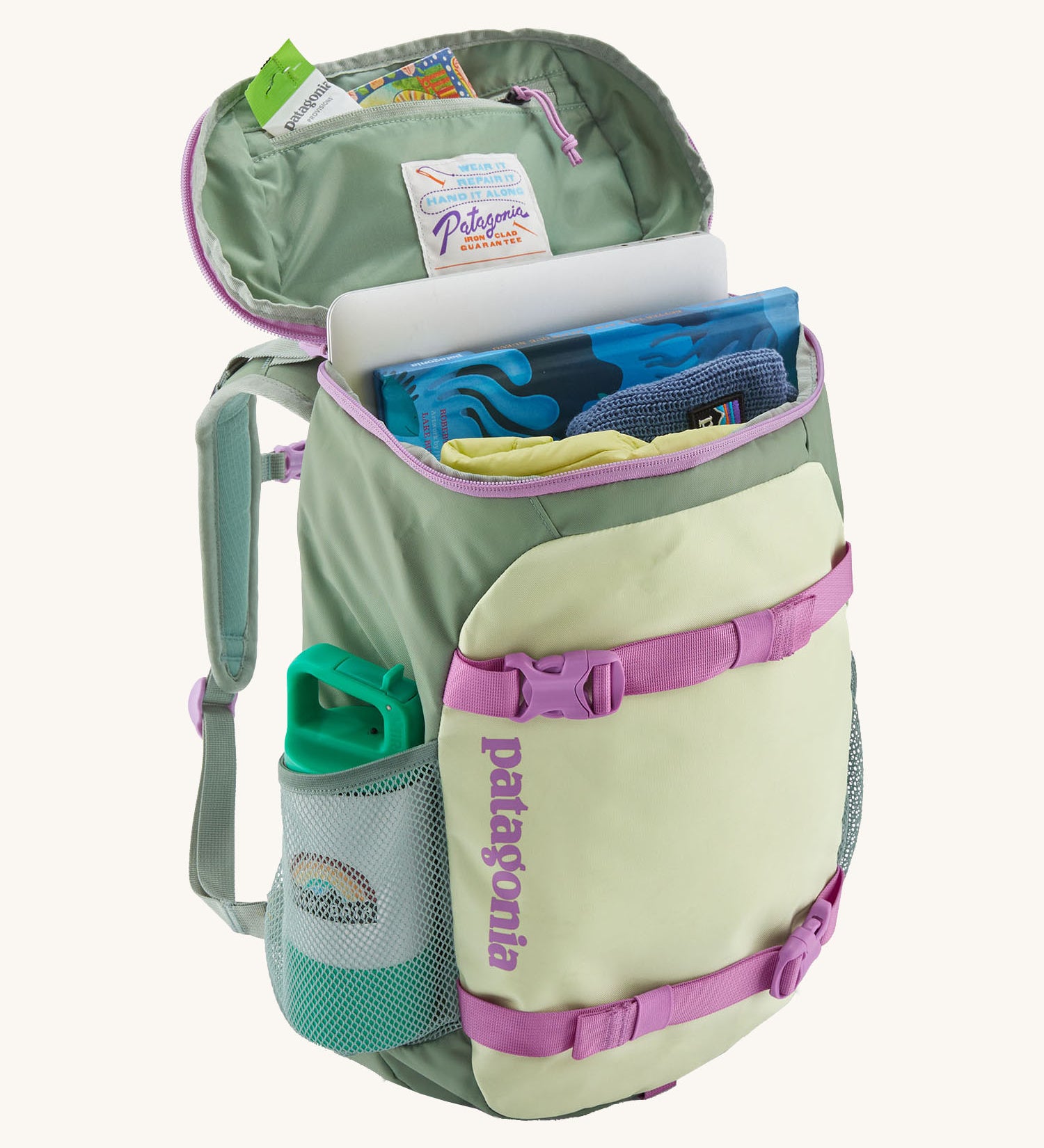 Patagonia refugito 18 litres daypack in ellwood green with the lid open revealing items in the main compartment and zip compartment on the inside.  Backpack available at Babipur.