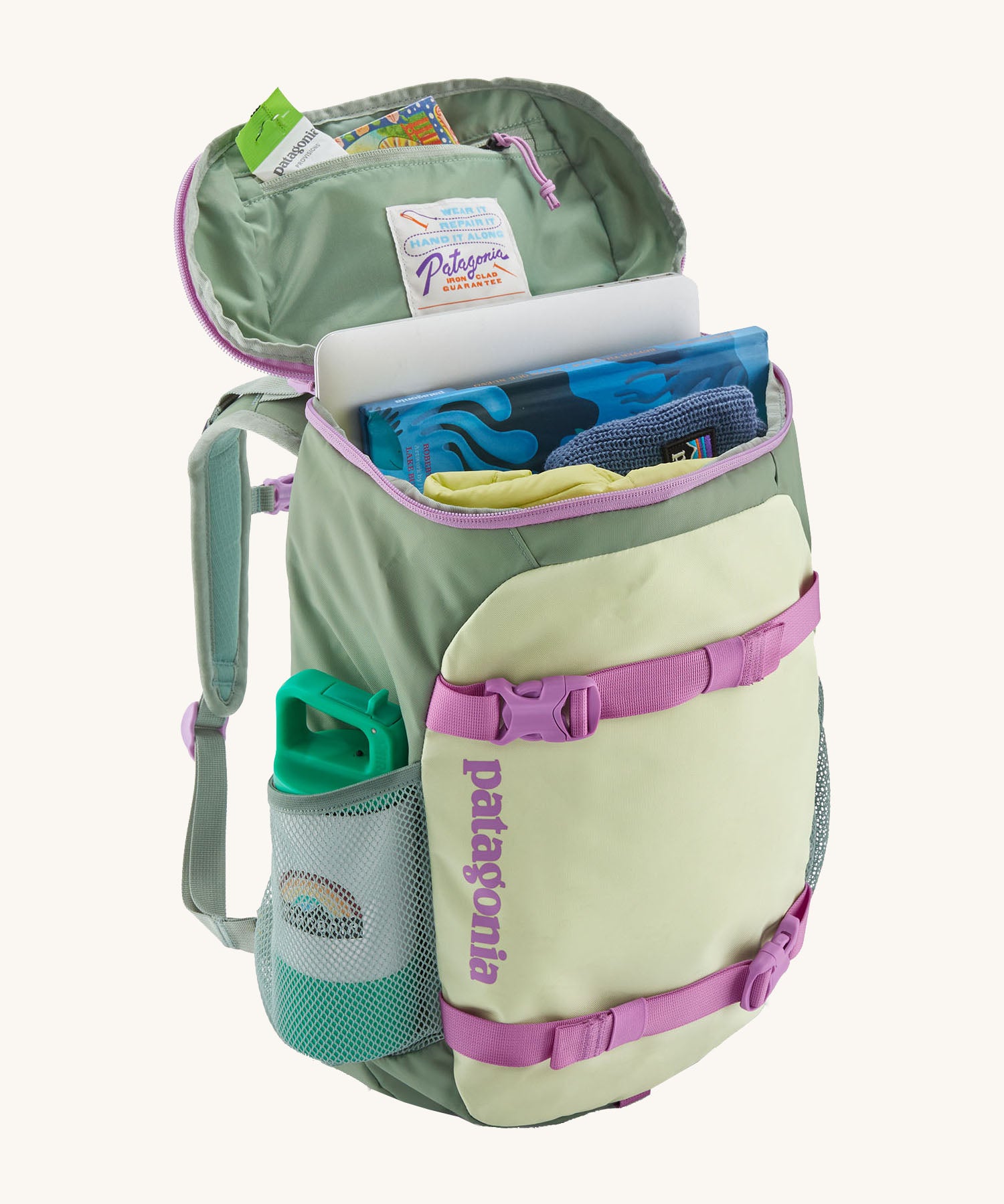 Patagonia refugito 18 litres daypack in ellwood green with the lid open revealing items in the main compartment and zip compartment on the inside.  Backpack available at Babipur.