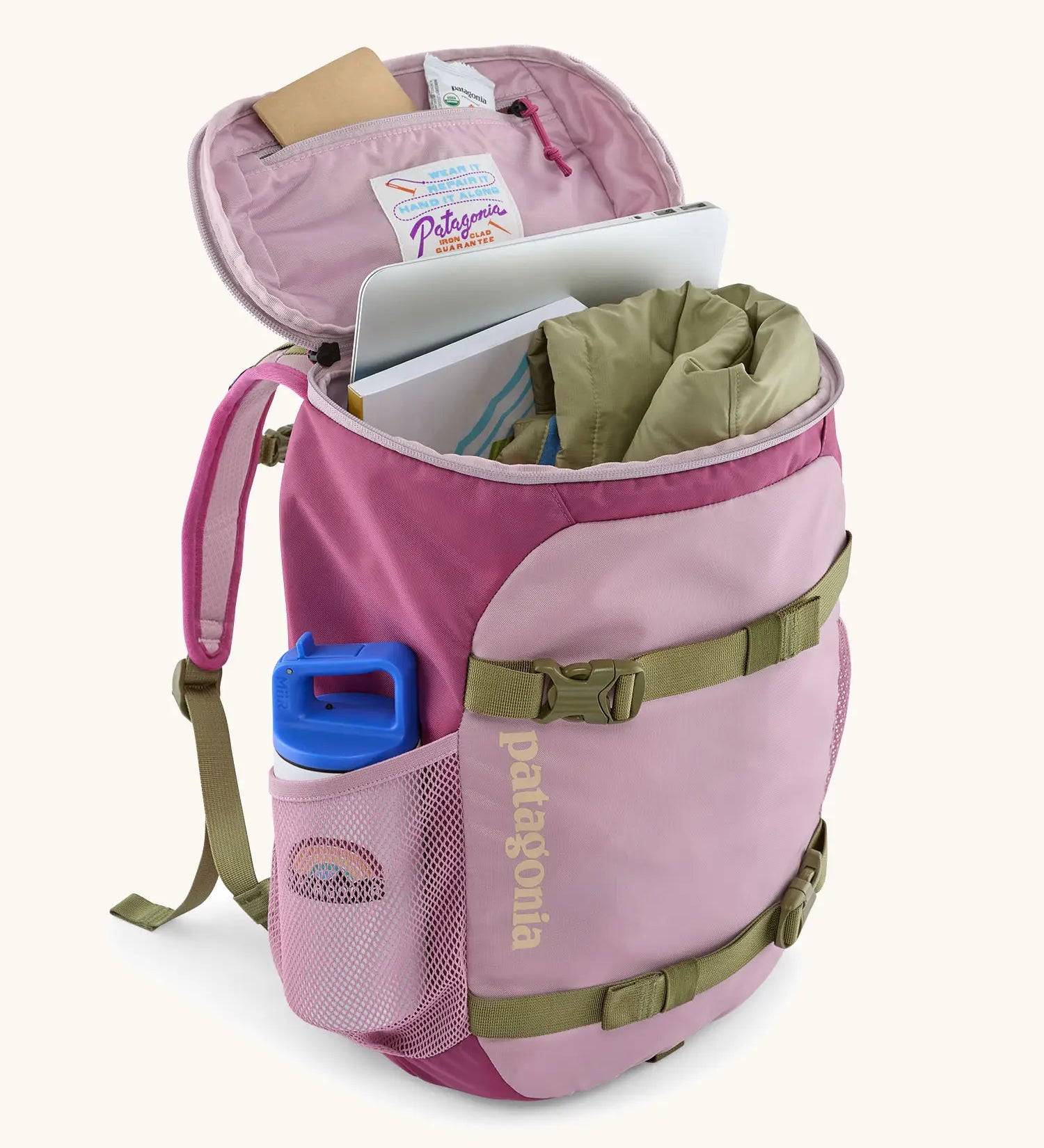 An open Patagonia kids refugito 18L day pack in pale purple with various items inside the main compartment and bottle in side pocket 