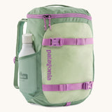 Patagonia refugito 18 litres daypack in ellwood green. A pastel green backpack with 2 side mesh pockets, pink buckle, fasteners on the front to keep it secure and a zip on the top for easy access with padded shoulder straps.