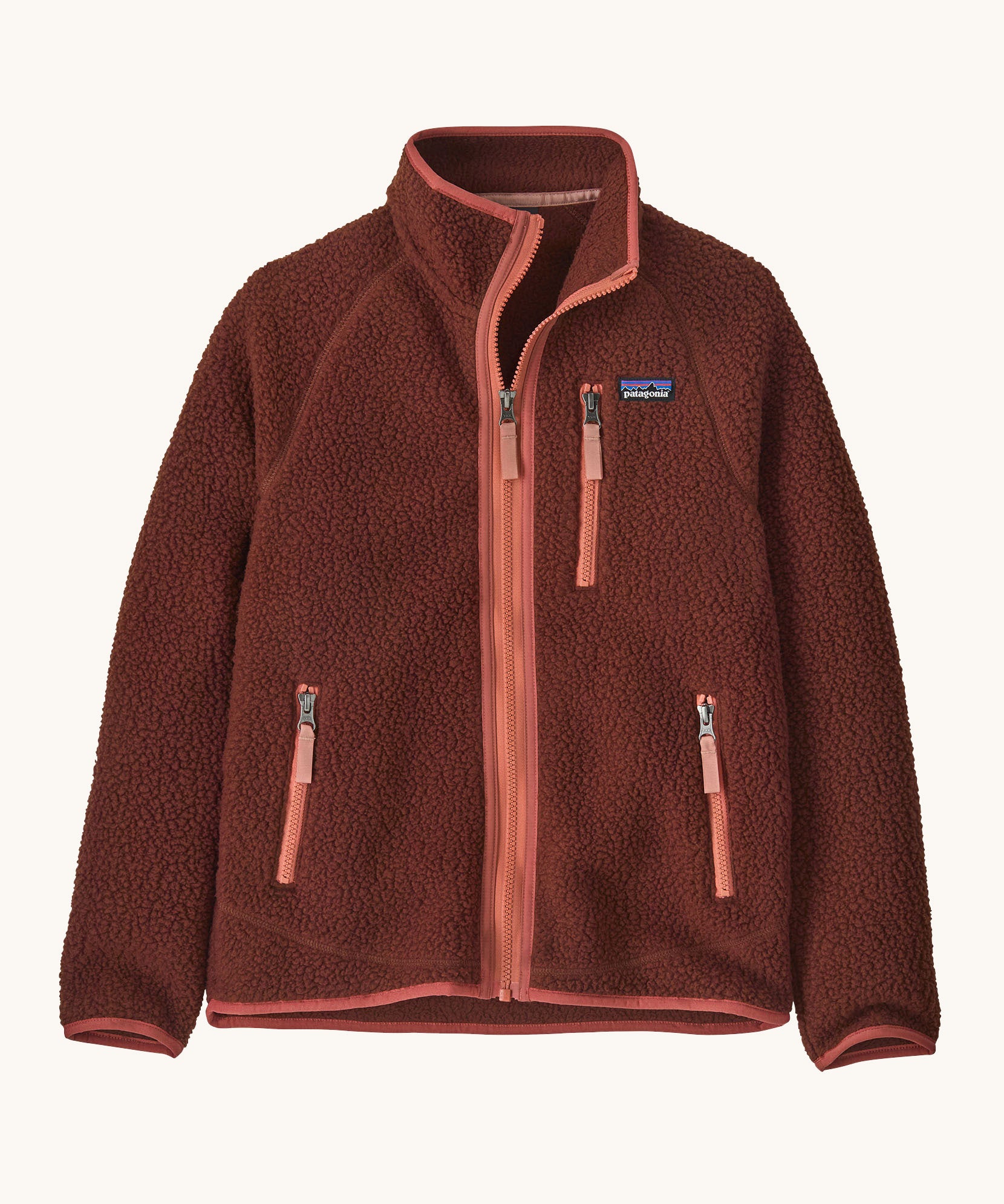 Patagonia kids retro pile fleece jacket in dried vanilla available at Babipur. A 100% recycled polyester thick fleece in dark red with pale red trim. Features a turn up collar, full length zip, 2 side zip pockets and chest pocket.