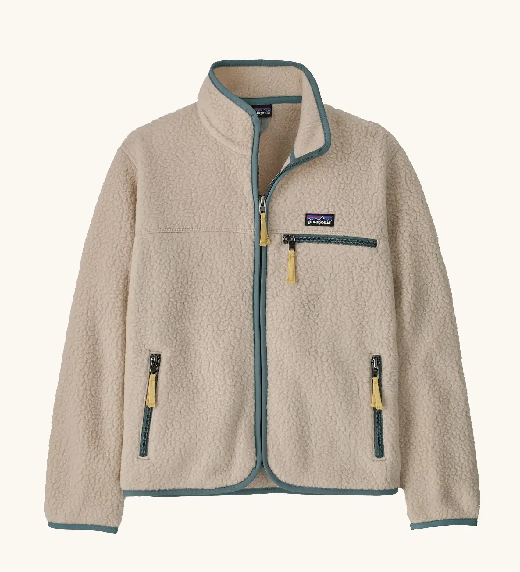 Patagonia Kids Retro Pile Jacket in Dark Natural. Cream fleece body with light sage green binding and zip pockets with pale yellow details.