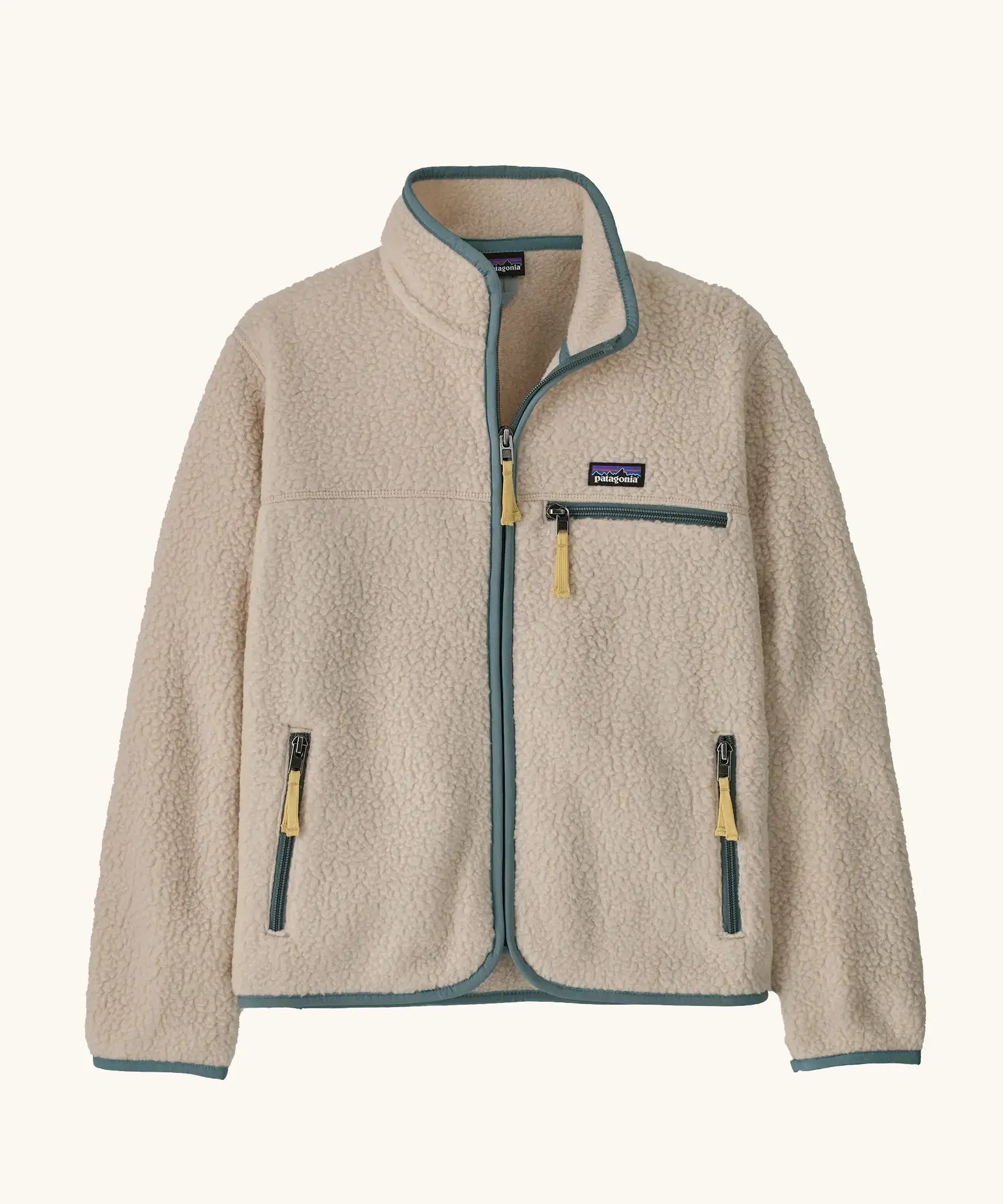 Patagonia Kids Retro Pile Jacket in Dark Natural. Cream fleece body with light sage green binding and zip pockets with pale yellow details.
