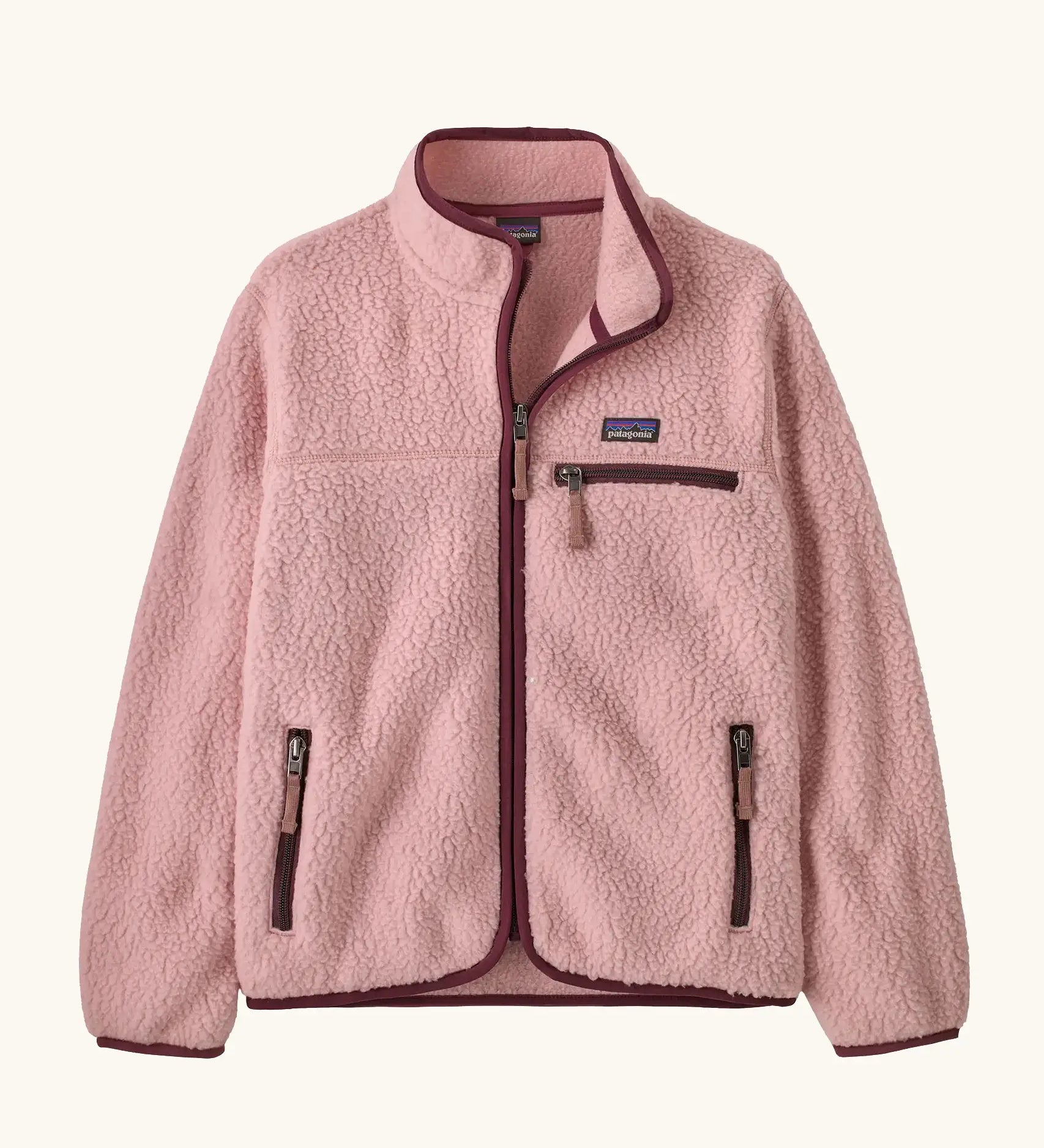 Patagonia Kids retro pile jacket in Fuzzy Mauve. Light pink fleece with maroon binding and contrasting zip pockets.
