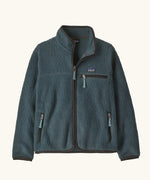Patagonia Kids Retro Pile Jacket in Summit Blue. Slate fleece body with three zip pockets and darker binding.