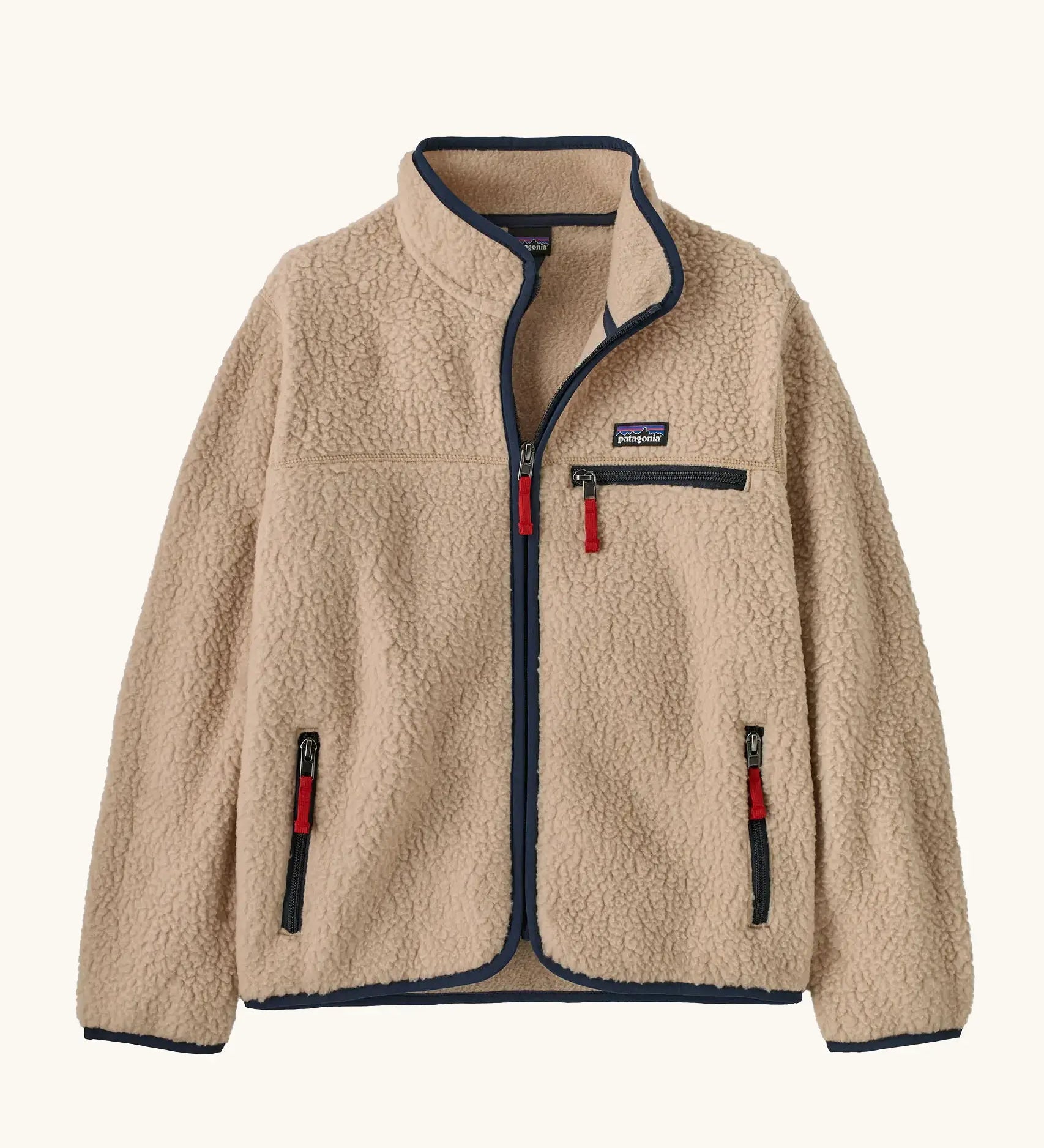Patagonia Kids Retro Pile Jacket in Valley Khaki. Cream fleece body with Navy blue binding and zip pockets with red details.
