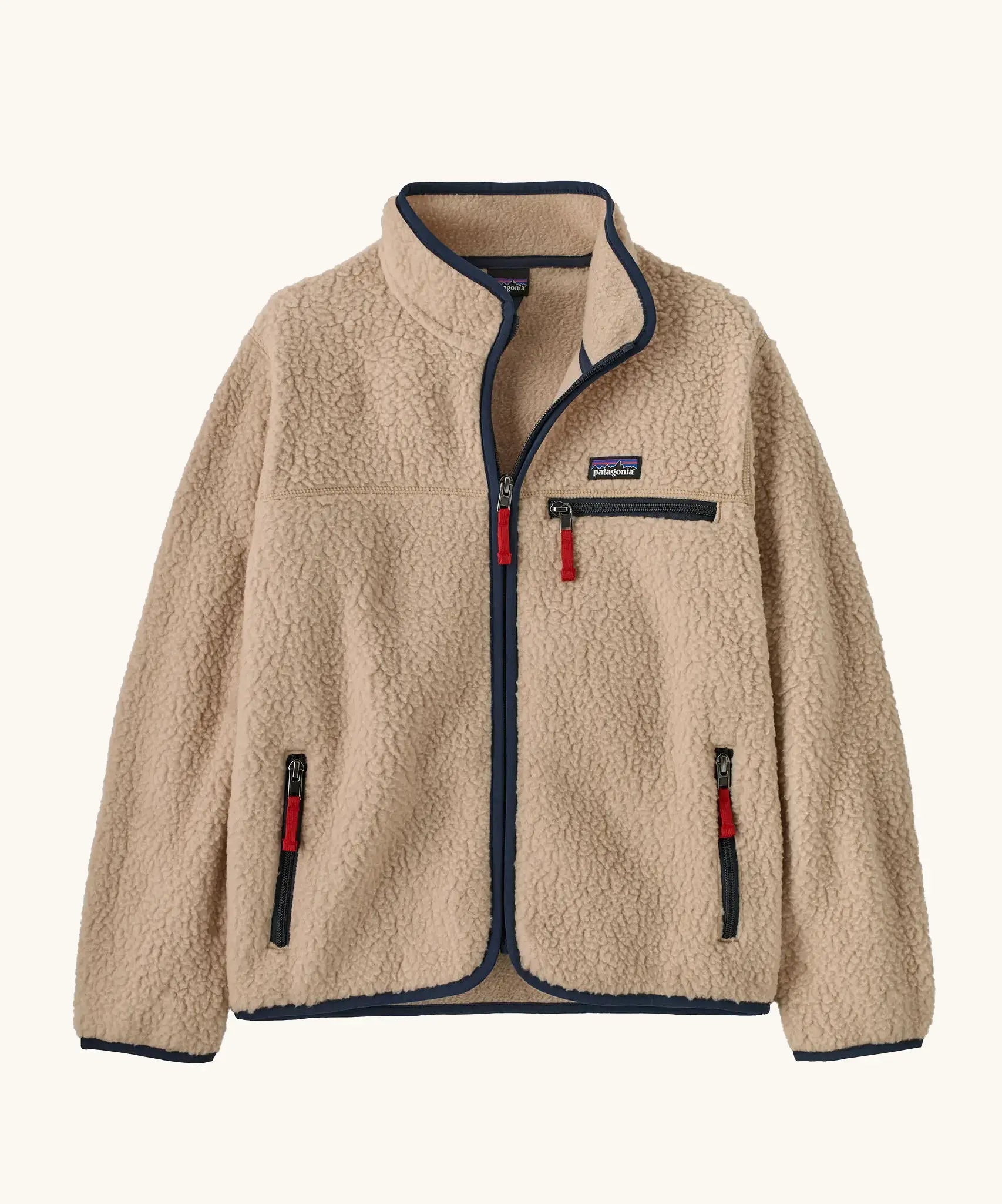 Patagonia Kids Retro Pile Jacket in Valley Khaki. Cream fleece body with Navy blue binding and zip pockets with red details.